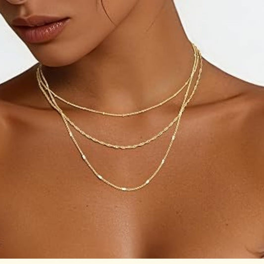 Guldkaskad – Elegant flerskikts halsband i varm guldton